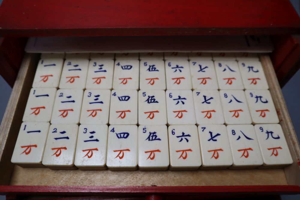 A Mah Jong set in red stained wood case